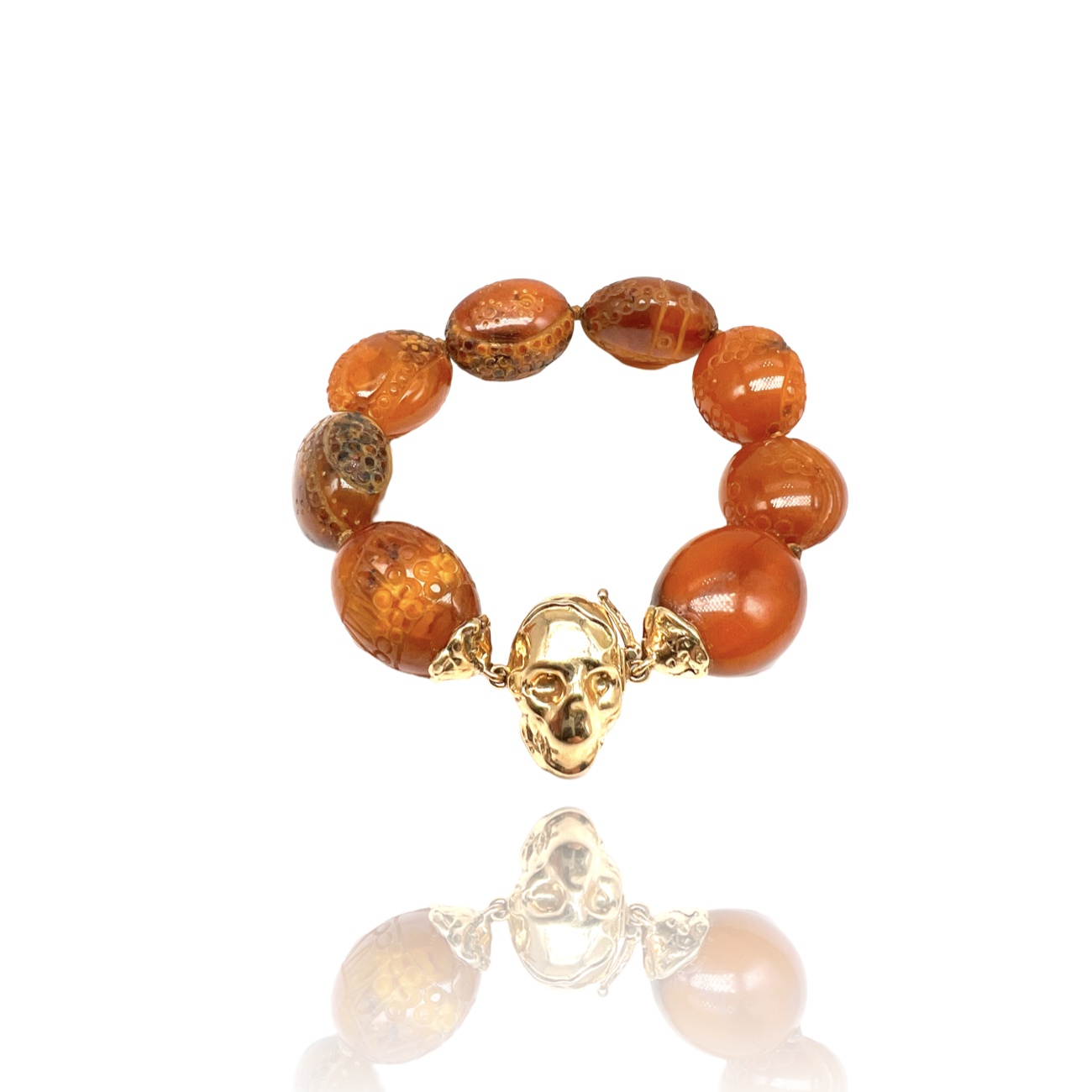 18 kt rose gold skull bracelet with carved amber